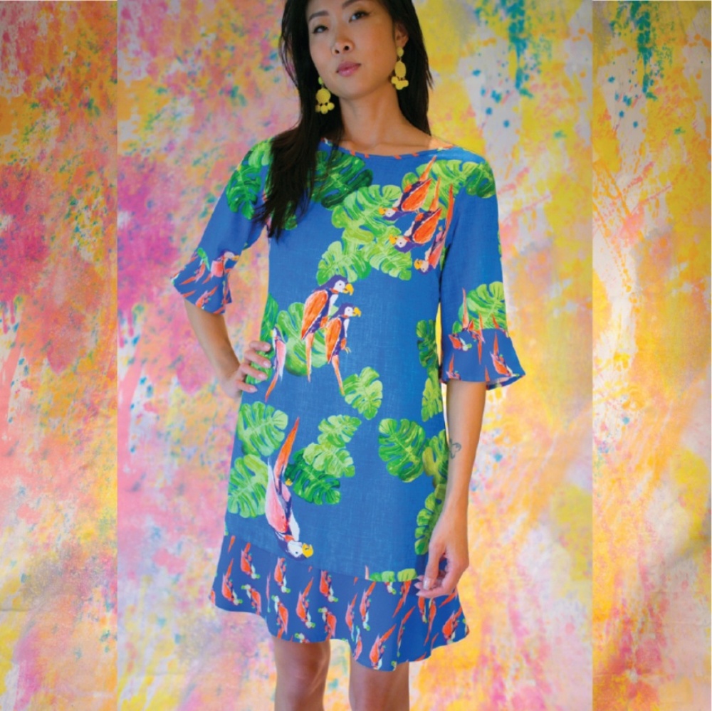Open back dress with ruffled hem and sleeves.